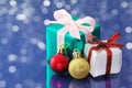 Small presents on blue sparkle background.