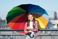 Small pretty girl standing with colorful umbrella. Girl on bridge. Hiding from sun with umbrella. Bright shades of girl Royalty Free Stock Photo