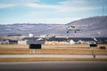 Small private aircraft landing on an airstrip overlooking the new community of Harmony.