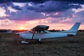 Small private airplane parked at the airfield at scenic sundown Royalty Free Stock Photo