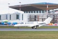 Small Private business Jet taxing on runway for take off, airport building on background. Business, travel, private aviation Royalty Free Stock Photo