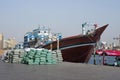 A small private no name merchant ship unloads bags with cotton