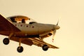 Small propeller plane landing or taking off on the runway of Sabadell airport with a totally orange sky in the afternoon Royalty Free Stock Photo