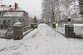 A bridge over a small river in winter, covered with a blanket of snow. Royalty Free Stock Photo