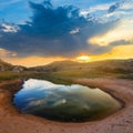 Small puddle among sandy prairie at the  sunset Royalty Free Stock Photo