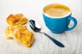 Small puff cookies, spoon, cup with coffee espresso on table