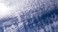 Small puffy clouds all over the bright blue sky Royalty Free Stock Photo