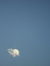 A small puffy white cloud in blue sky Royalty Free Stock Photo