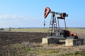 Small Pump Jack in agricultural field Royalty Free Stock Photo