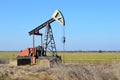 Small Pump Jack in agricultural field Royalty Free Stock Photo