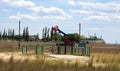 Small pump. Oil pump . Equipment for the oil industry. Oil rocking chair in the open air Royalty Free Stock Photo