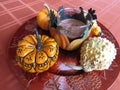 Small pumpkins and gourds of various colors, displayed on platters from various angles and depth Royalty Free Stock Photo