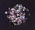 Small purple jewel stones heap over black silk Royalty Free Stock Photo