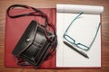 Small purse and notebook and pen and reading glasses flat lay - red and black leather with turquoise glasses and lined notebook pa Royalty Free Stock Photo