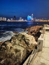 Small Qingdao Park waves and distant city night scenery