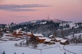 Small and quiet alpine village and winter sunrise snowy mountains around, Voronenko, Carpathian, Ukraine Royalty Free Stock Photo