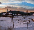 Small and quiet alpine village and winter sunrise snowy mountains around, Voronenko, Carpathian, Ukraine