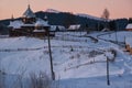 Small and quiet alpine village and winter sunrise snowy mountains around, Voronenko, Carpathian, Ukraine Royalty Free Stock Photo