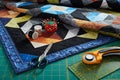 Small quilt, cutting mat and sewing and quilting accessories Royalty Free Stock Photo