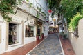 Small quite narrow street with traditional Andalusian architecture.