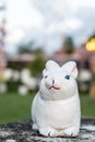 Small rabbit statue with blurred outdoor background Royalty Free Stock Photo