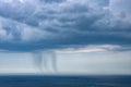 Small rain over the sea from a cloud