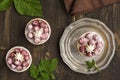 Small raspberry cheesecakes over grunge wooden table