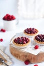 Small raspberry tarts on bright background