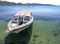 A small recreational passenger boat stands in the sea at the port of the Greek island of Evia in Greece Royalty Free Stock Photo