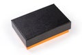Small rectangular cardboard box orange color closed with black lid Royalty Free Stock Photo