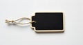 Black chalkboard tag with twine against a white background Royalty Free Stock Photo
