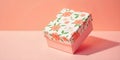 A small, rectangular gift box adorned with a floral pattern featuring orange and pink flowers with green leaves Royalty Free Stock Photo