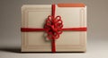 A small rectangular gift box with a red ribbon tied in an intricate symmetrical knot on a plain white background Royalty Free Stock Photo