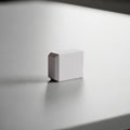A small, rectangular, pale pink object on a smooth, gray surface Royalty Free Stock Photo
