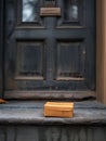 a small wooden box sits on the steps of a door Royalty Free Stock Photo