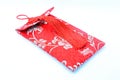 Small red bag with Chinese fabric design over white background Royalty Free Stock Photo