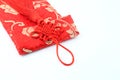 Small red bag with Chinese fabric design over white background Royalty Free Stock Photo