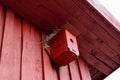 Small red bird house with nest on top Royalty Free Stock Photo