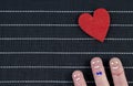 Small red and black hearts on a blue background in a row Royalty Free Stock Photo