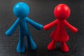 Small red and blue plastic toy copleFigurines of an couple Royalty Free Stock Photo
