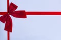 small red bow on a white background with red ribbons Royalty Free Stock Photo