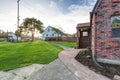 Small red brick home on a sunny day Royalty Free Stock Photo