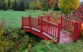 Small red bridge in a park during autumn time Royalty Free Stock Photo