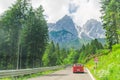 Small red car on the road through mountains road trip Royalty Free Stock Photo