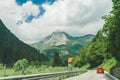 Small red car on the road through mountains road trip Royalty Free Stock Photo