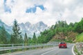small red car on the road through mountains road trip Royalty Free Stock Photo