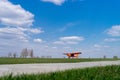 Small red charter airplane waiting on a green field to take off Royalty Free Stock Photo