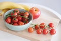 Small red cherry tomatoes on rustic background. Cherry tomatoes on the vine Royalty Free Stock Photo