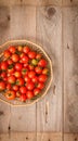 Small red cherry tomatoes in a wicker basket Royalty Free Stock Photo