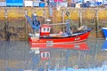 A small Red fishing boat moored in the harbour. Royalty Free Stock Photo